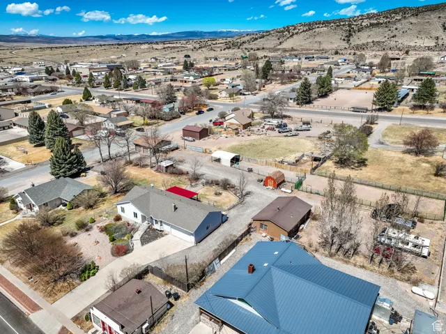 Aerial perspective showcasing a residential neighborhood with distant mountainous terrain