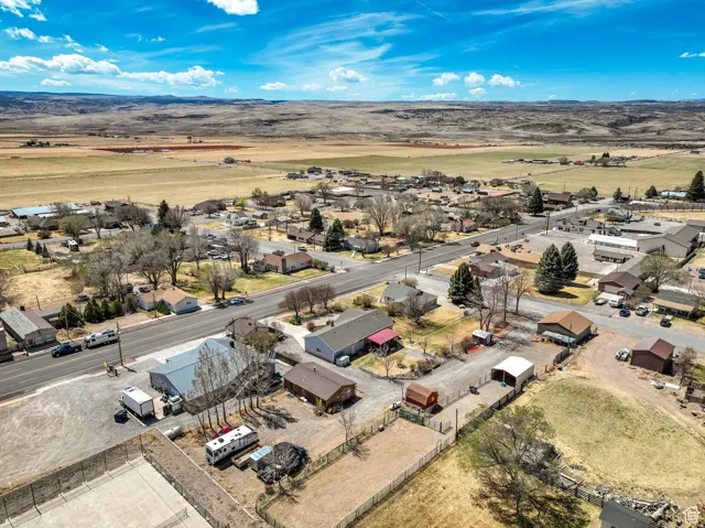 Aerial perspective showcasing a residential and commercial area with expansive surrounding landscapes