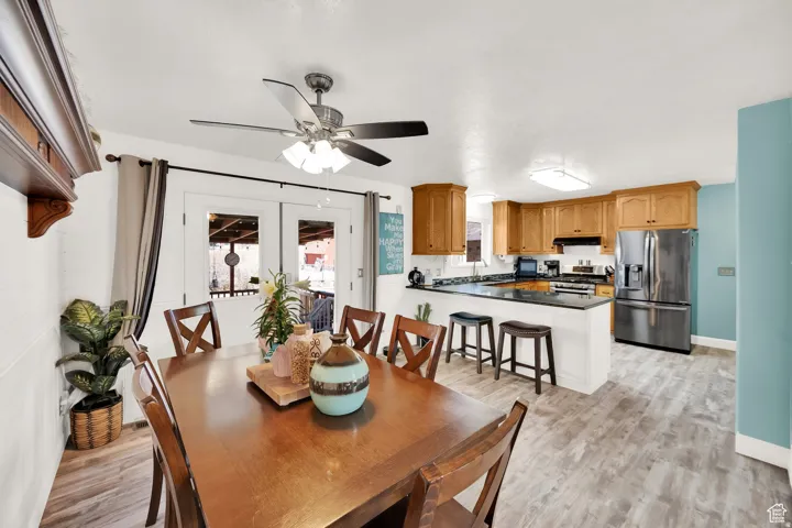 Combined kitchen and dining area featuring wood-finish flooring