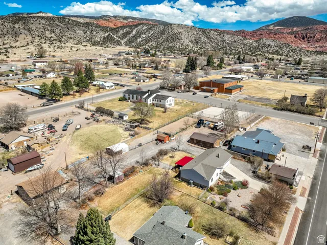 Aerial perspective showcasing a residential area set against a mountainous backdrop