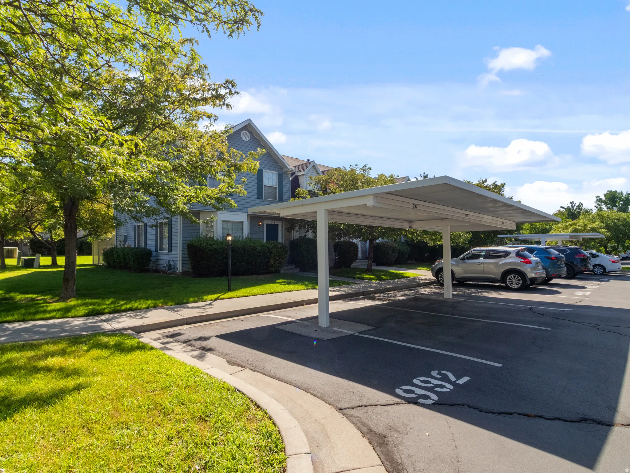 Carport parking with multiple covered spaces and paved lot