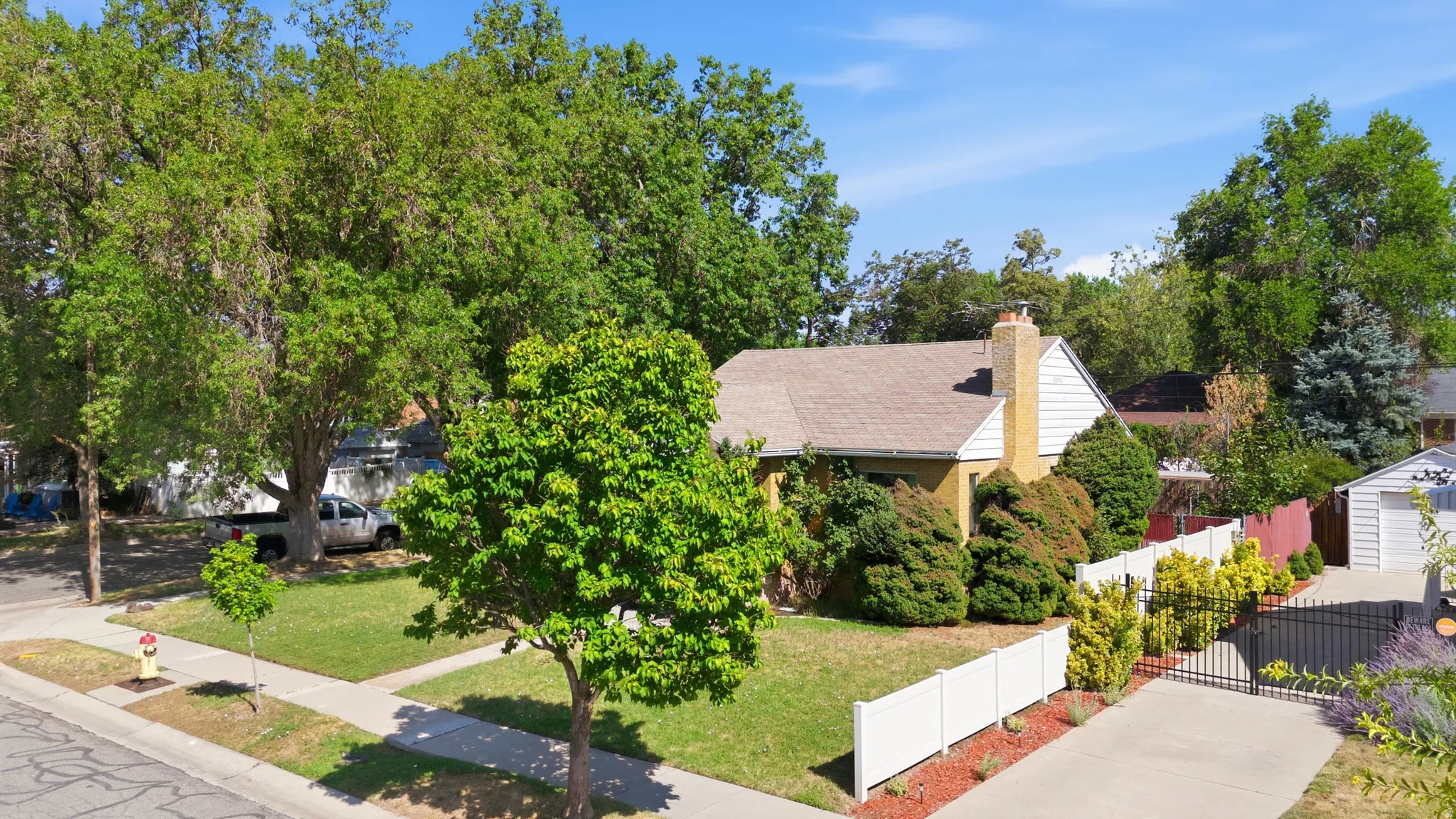 Traditional single-story residence featuring a prominent brick chimney and a light-colored roof