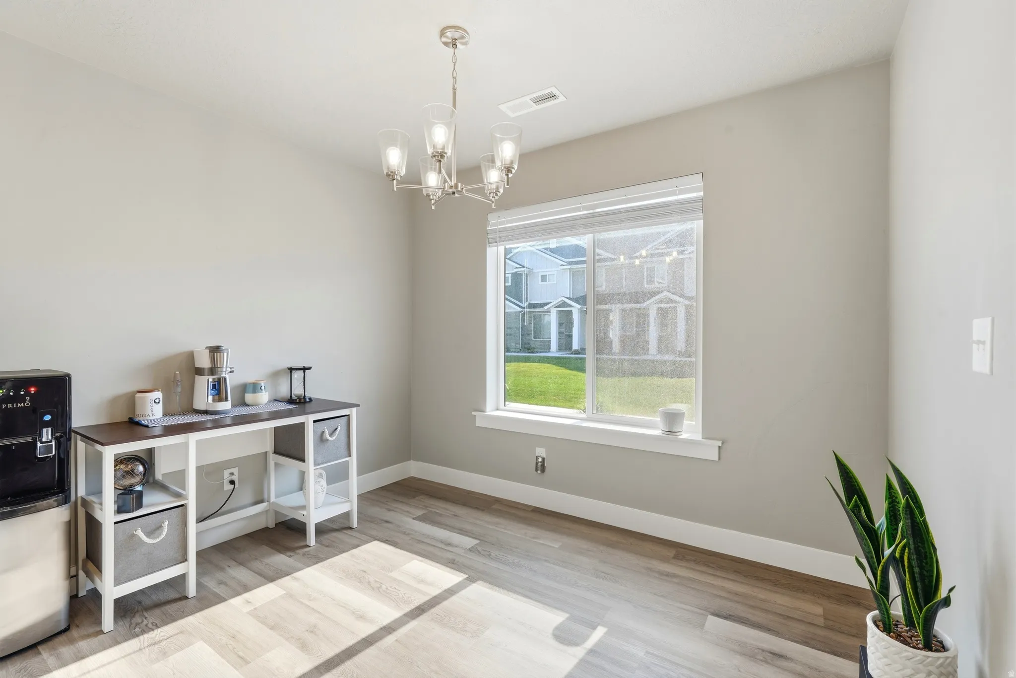 Interior space featuring light gray walls and wood-finish flooring
