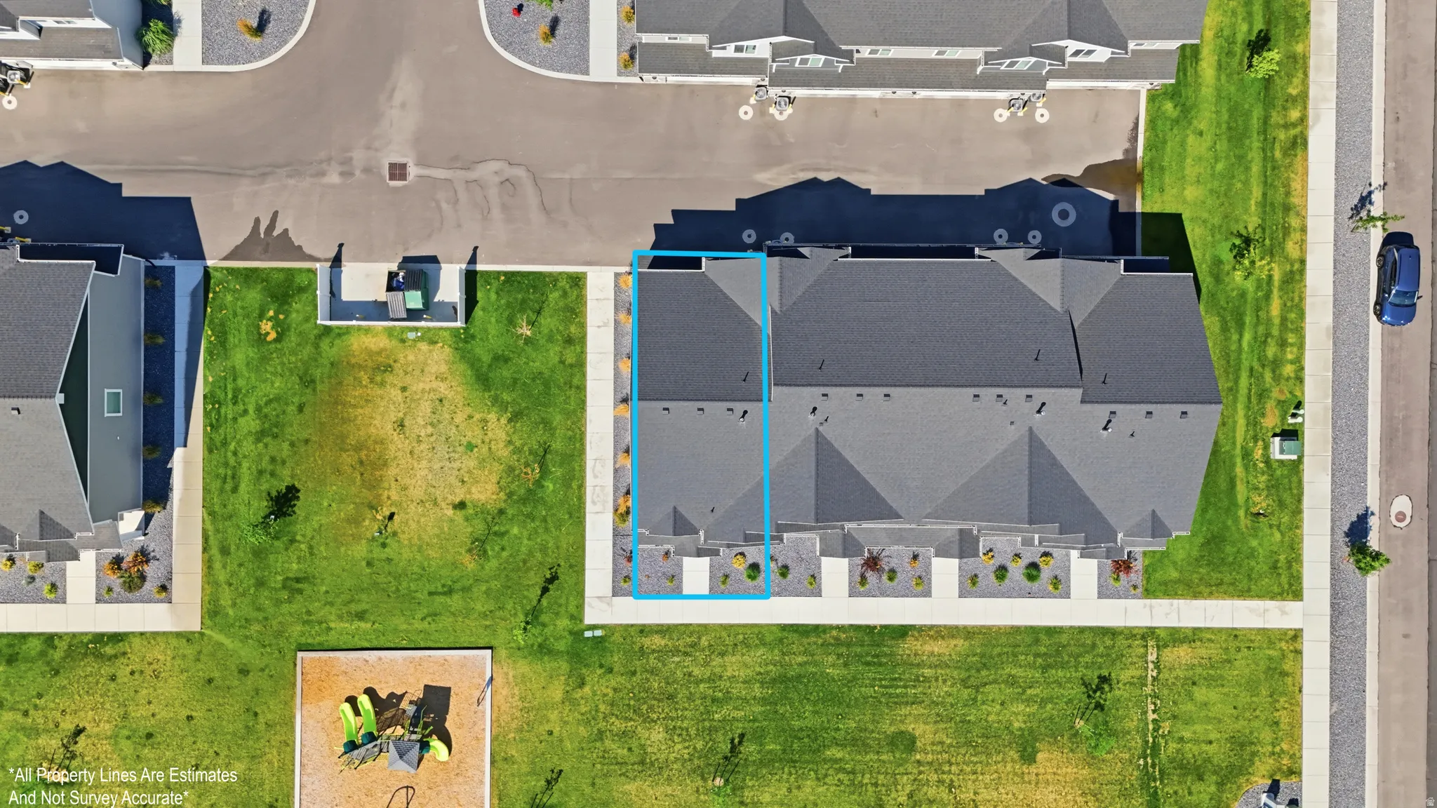 Aerial perspective of a multi-unit residential property with a dark shingle roof