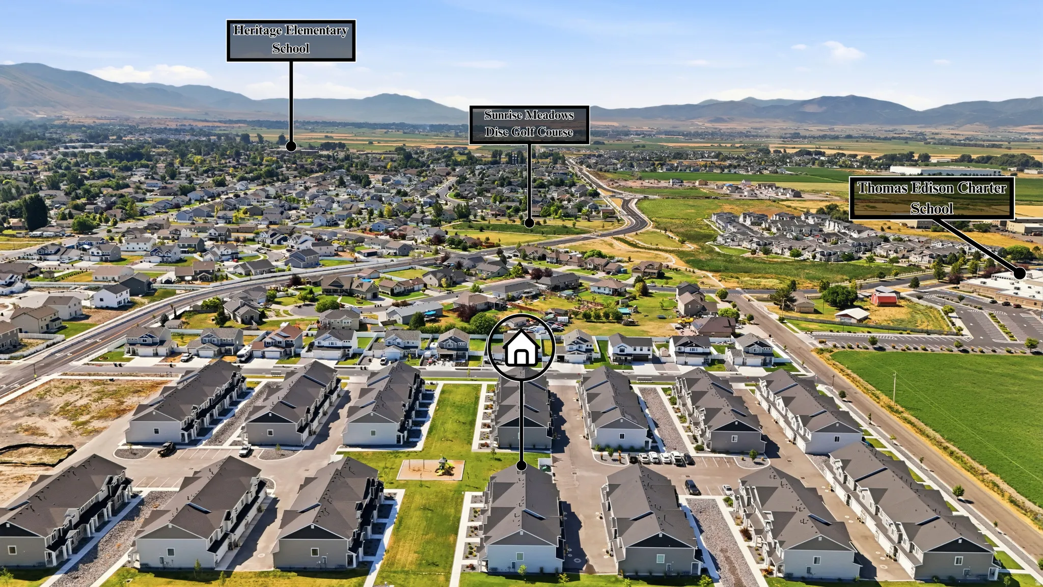 Aerial view of a residential development with multiple rows of townhomes