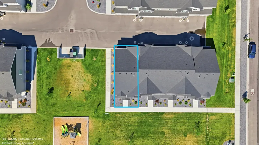Aerial perspective of a multi-unit residential property with a dark shingle roof