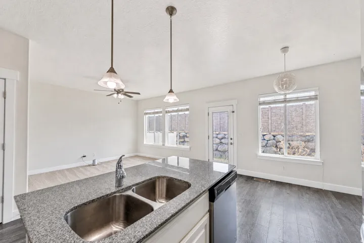 Kitchen island with granite countertop and dual basin stainless steel sink