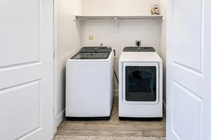 Dedicated laundry area featuring a shelf and hanging rod