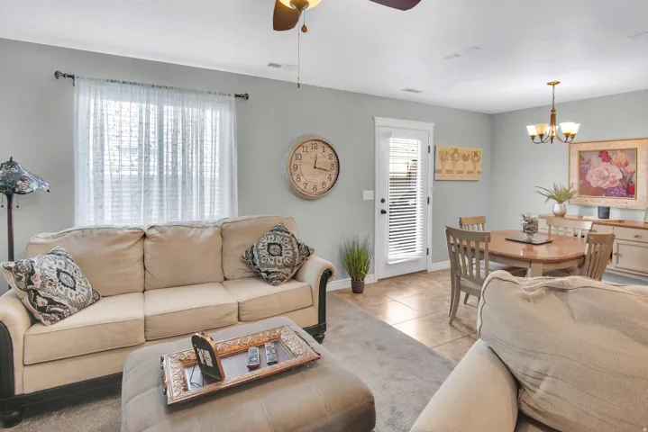 Open-concept living area with light gray wall tones