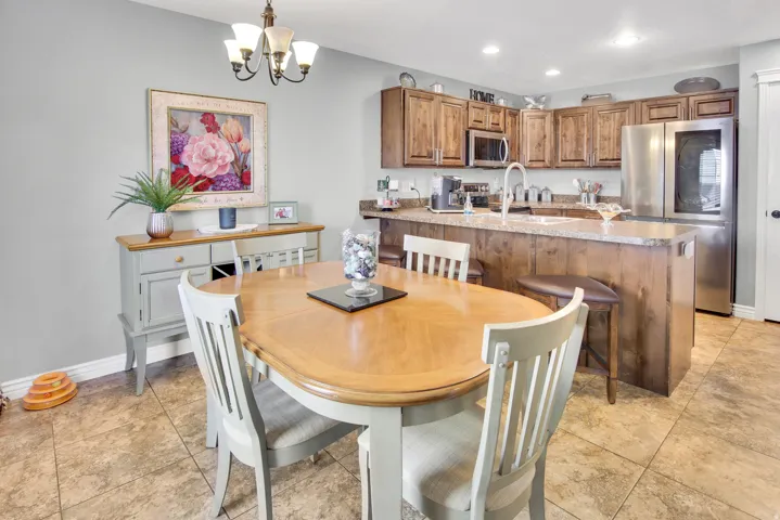 Kitchen featuring wood-finish cabinetry, granite-style countertops, and stainless-steel appliances