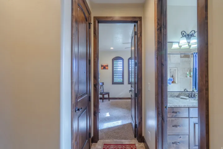 Hallway with warm-toned walls, featuring wood-finish doors and trim