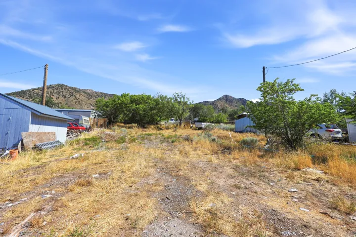 Expansive undeveloped lot featuring natural vegetation and distant mountain scenery
