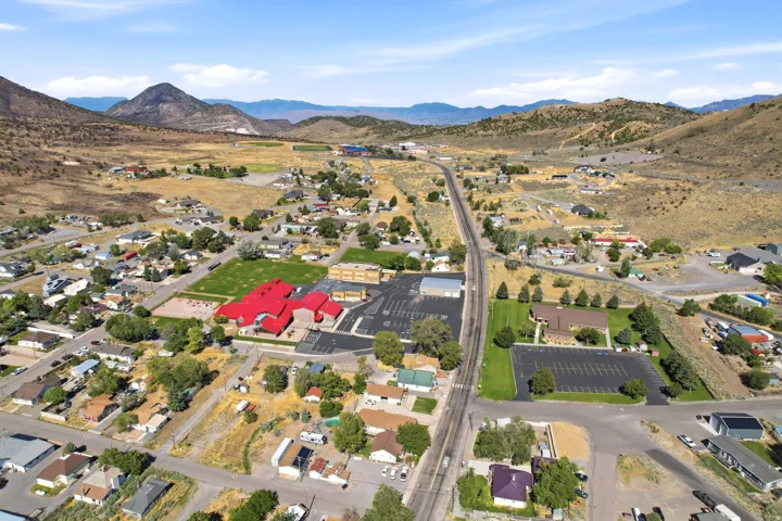 Expansive aerial perspective showcasing a residential community nestled within a mountainous landscape