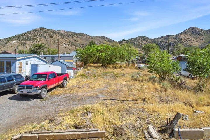 Expansive undeveloped lot featuring natural vegetation and distant mountain ranges