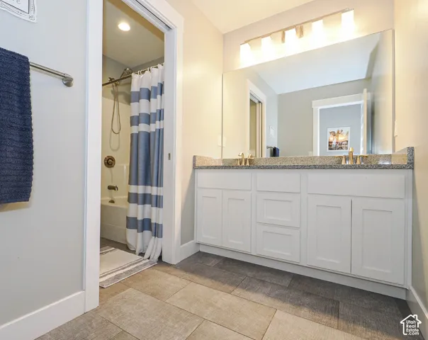 Dual vanity bathroom with separate tub and toilet area