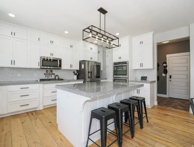 Large island in kitchen with double ovens