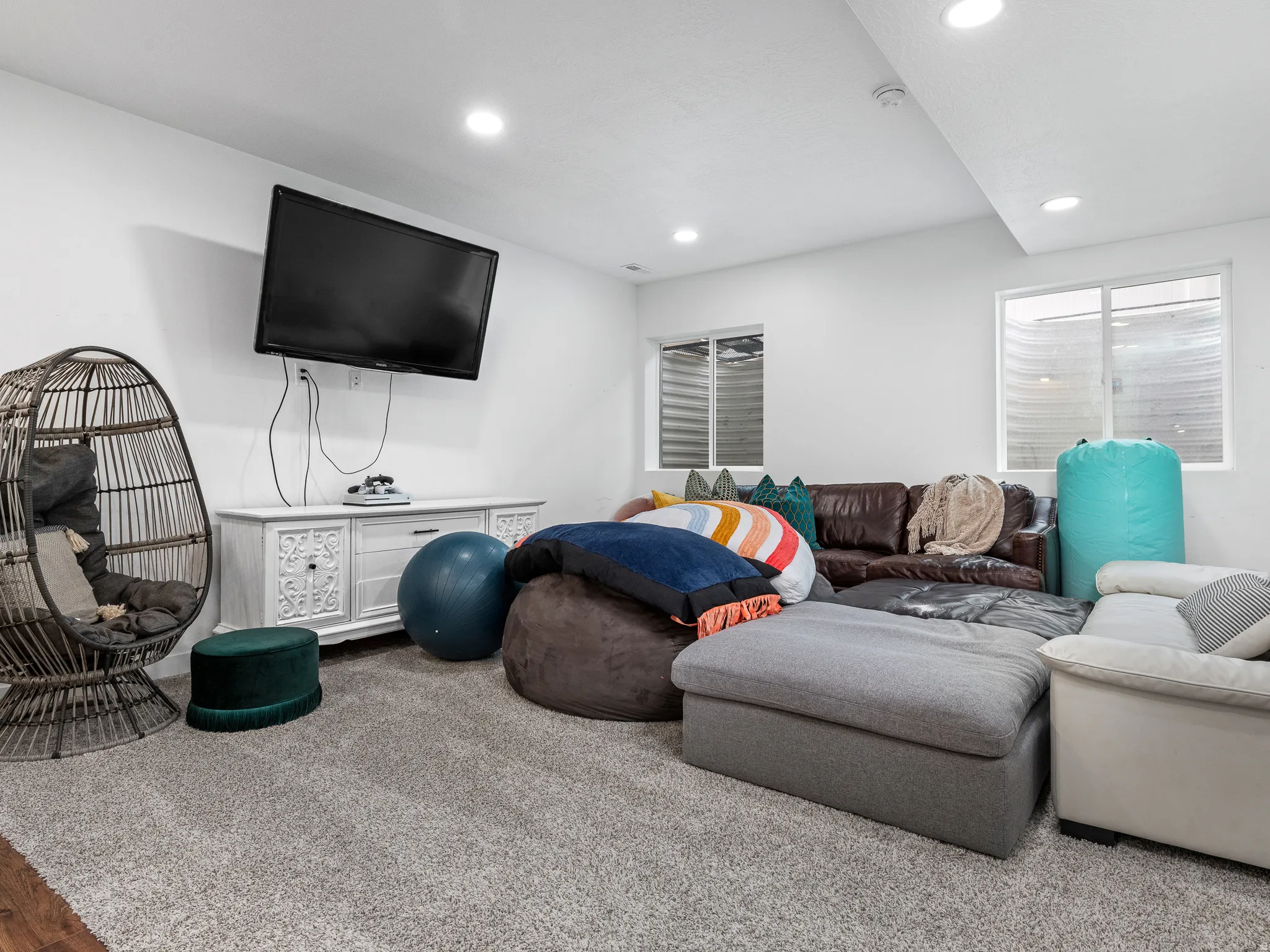 Spacious room featuring light-colored carpet flooring, recessed lighting, and white walls