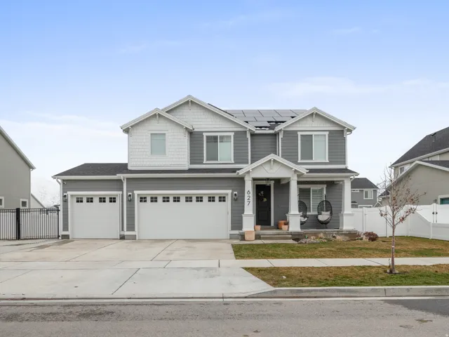 Contemporary two-story residence featuring gray siding and white trim