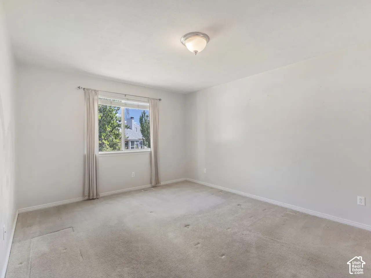 Neutral-toned carpet flooring and light gray walls