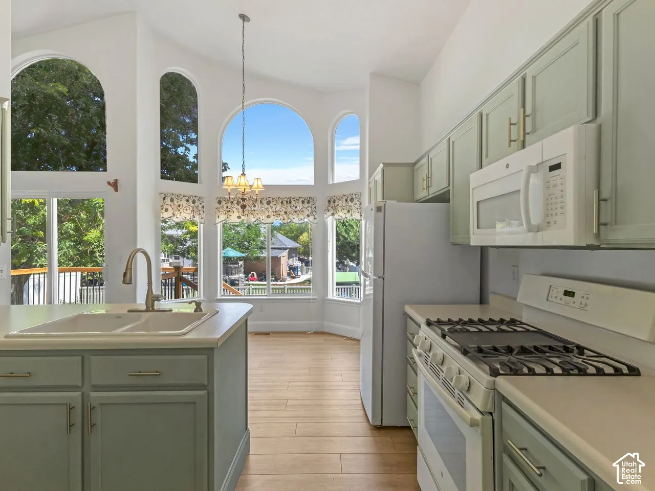 Kitchen featuring light-toned cabinetry, a built-in microwave, and a gas range