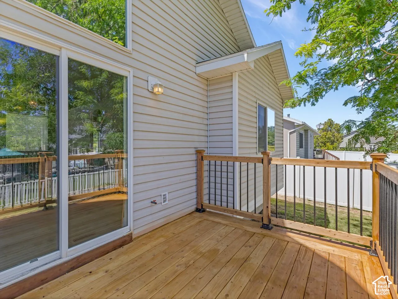 Expansive wood deck with black metal spindle railing and natural wood posts