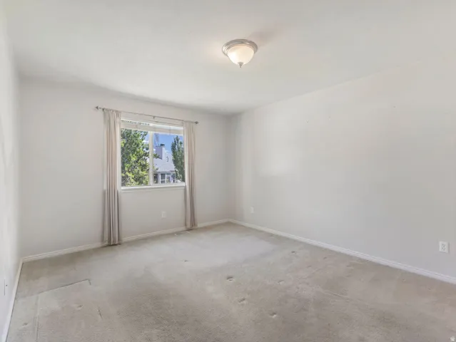 Neutral-toned carpet flooring and light gray walls