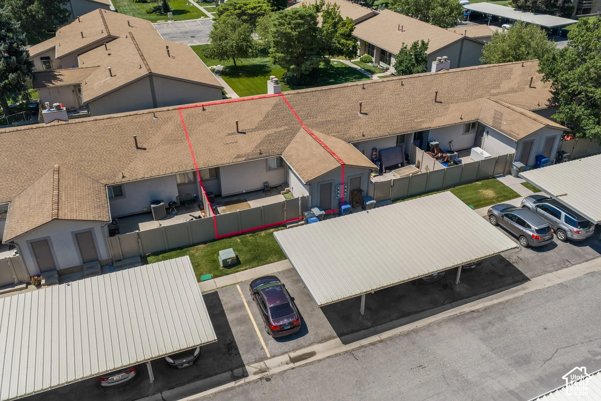 Townhome-style residence featuring a private patio space, enclosed by a privacy fence