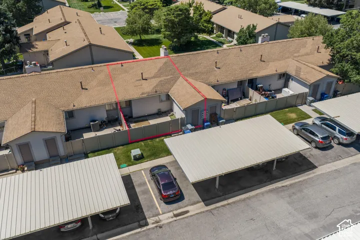 Townhome-style residence featuring a private patio space, enclosed by a privacy fence