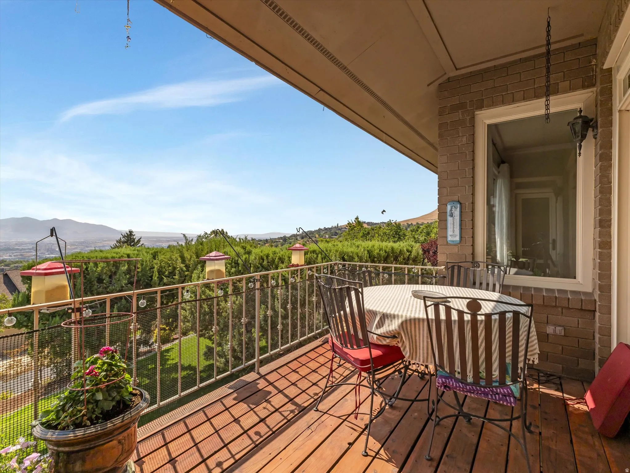 Expansive balcony with wood-finish decking and an ornate metal railing