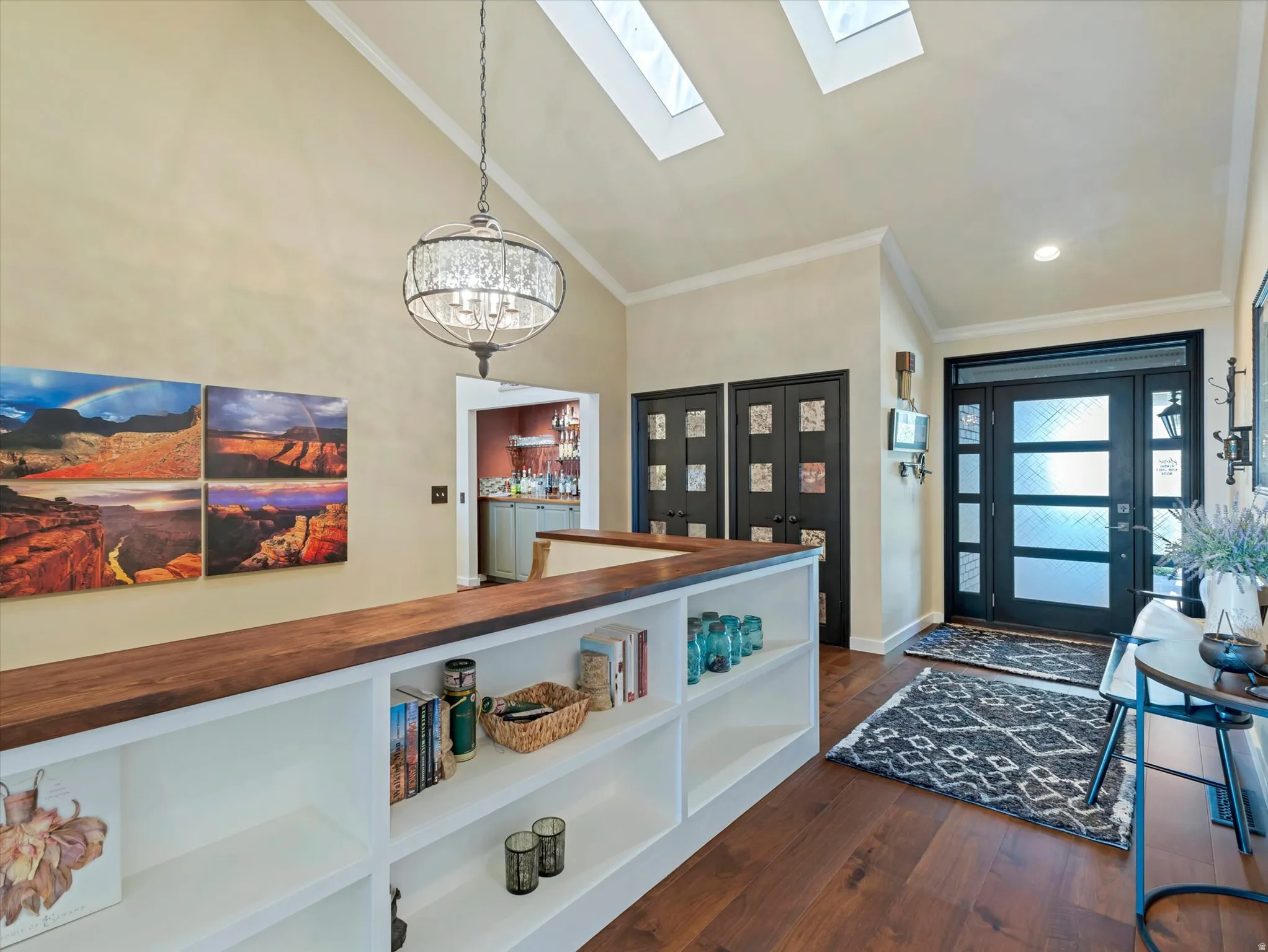 Vaulted ceiling with multiple skylights and crown molding