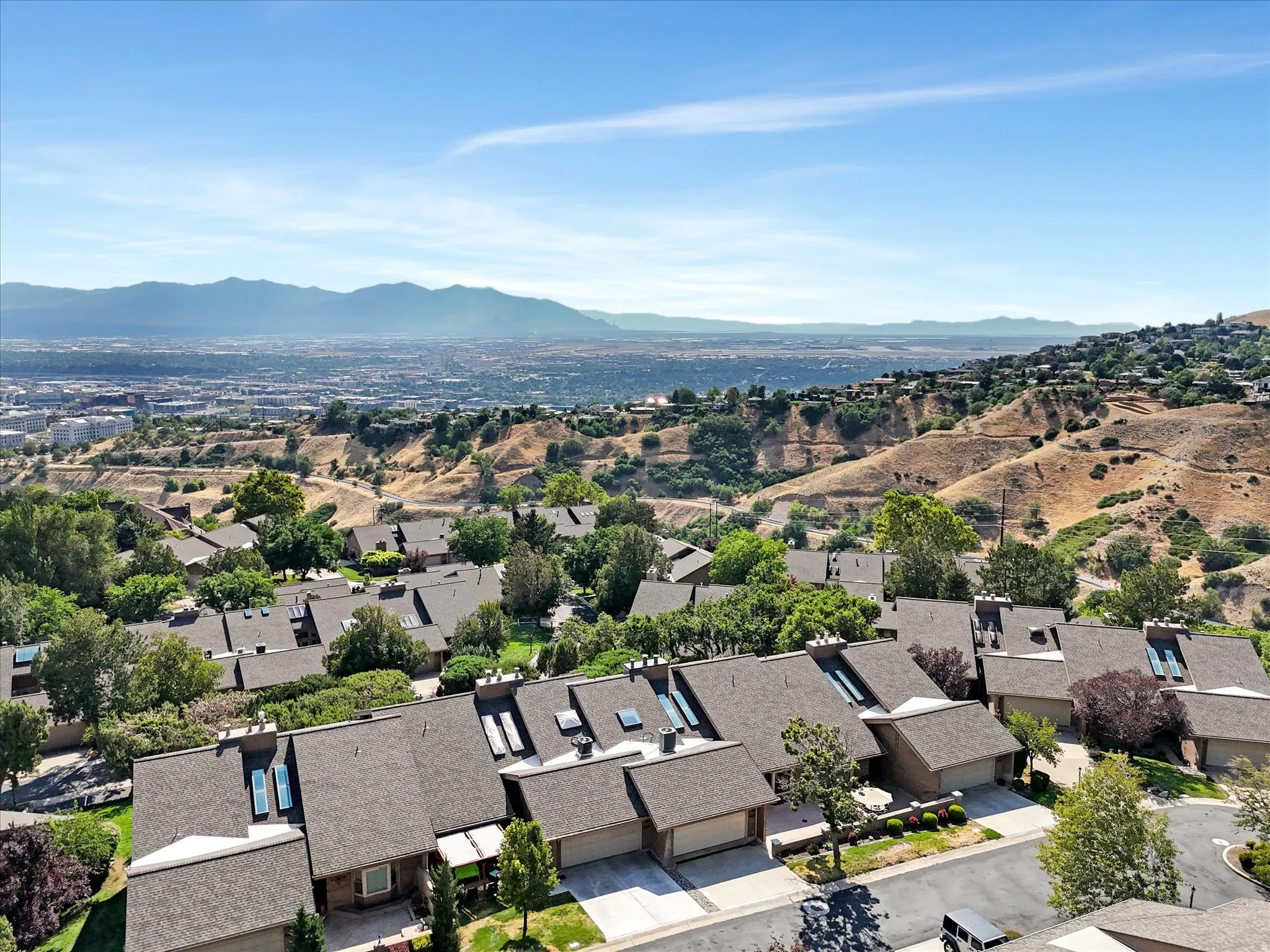 Terraced residential development featuring a hillside setting and expansive mountain backdrop