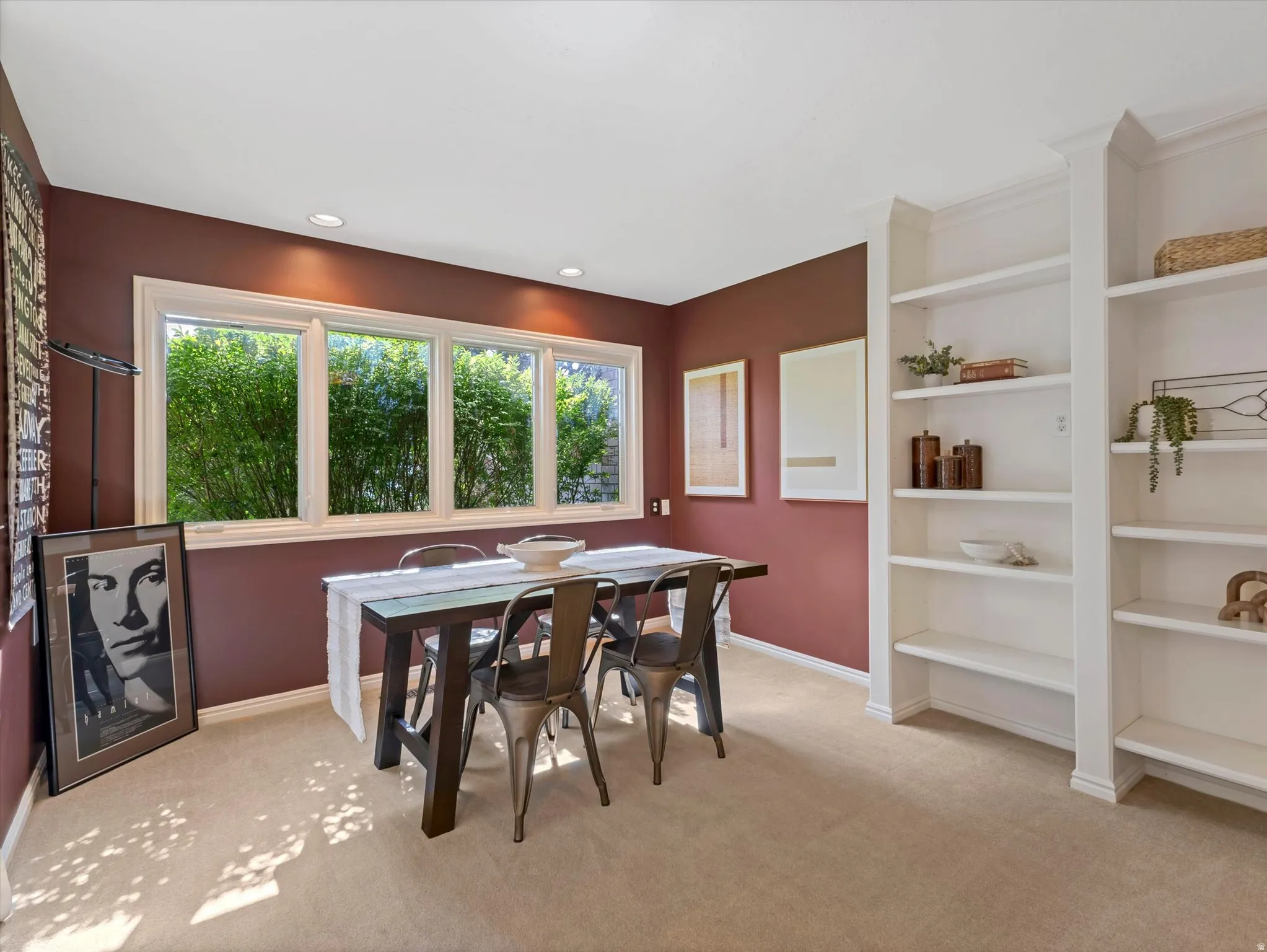 Room featuring recessed lighting, extensive built-in shelving, multiple windows with white trim, and light-toned carpeting
