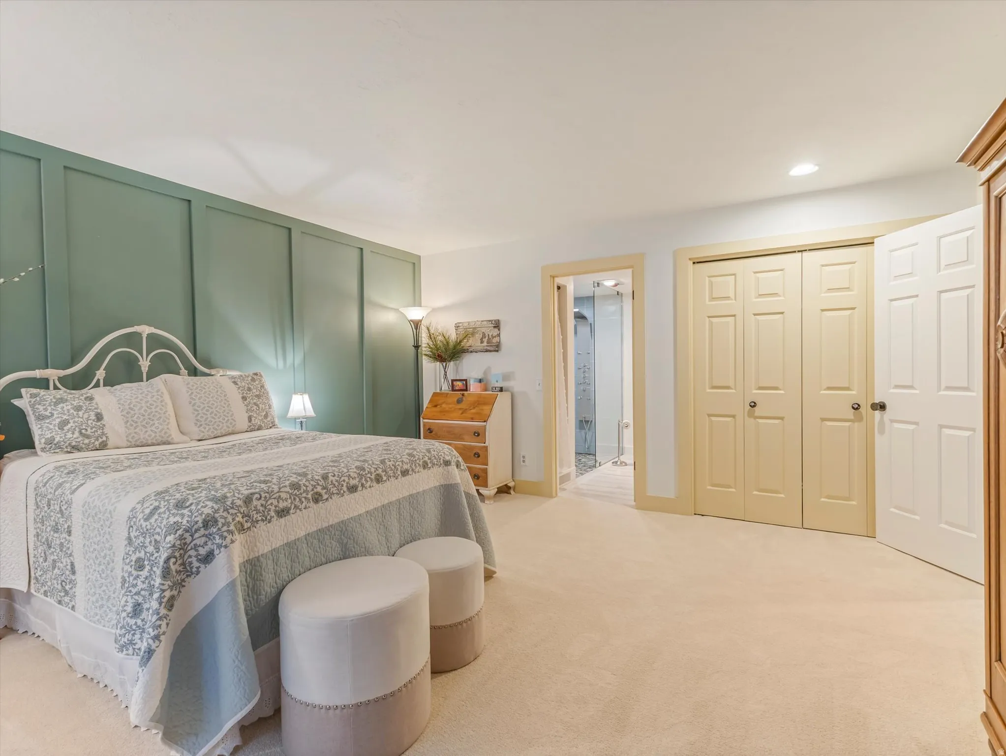 Bedroom featuring a paneled accent wall, neutral carpeting, and recessed lighting