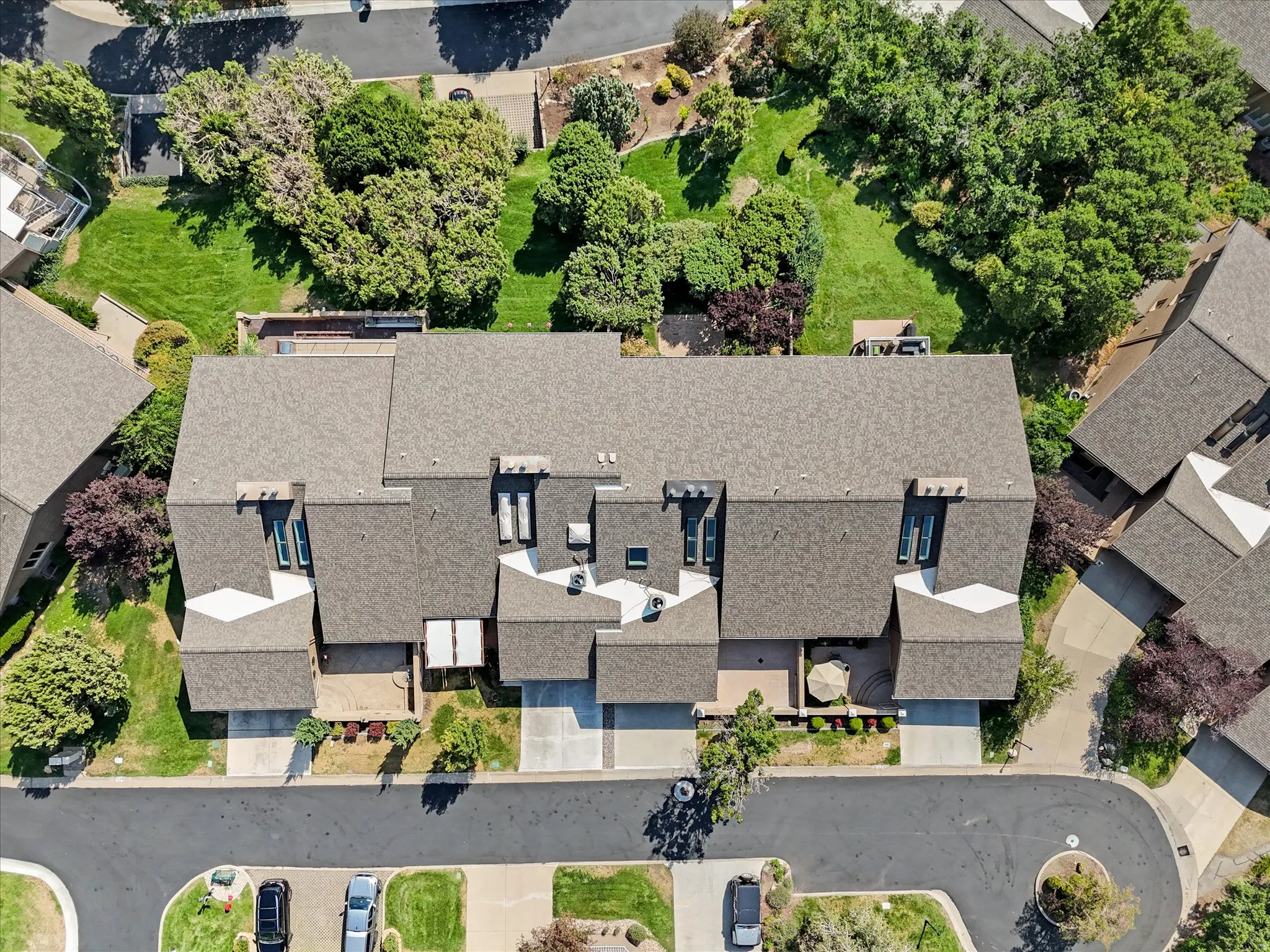 Townhouse complex featuring multiple units with individual driveways