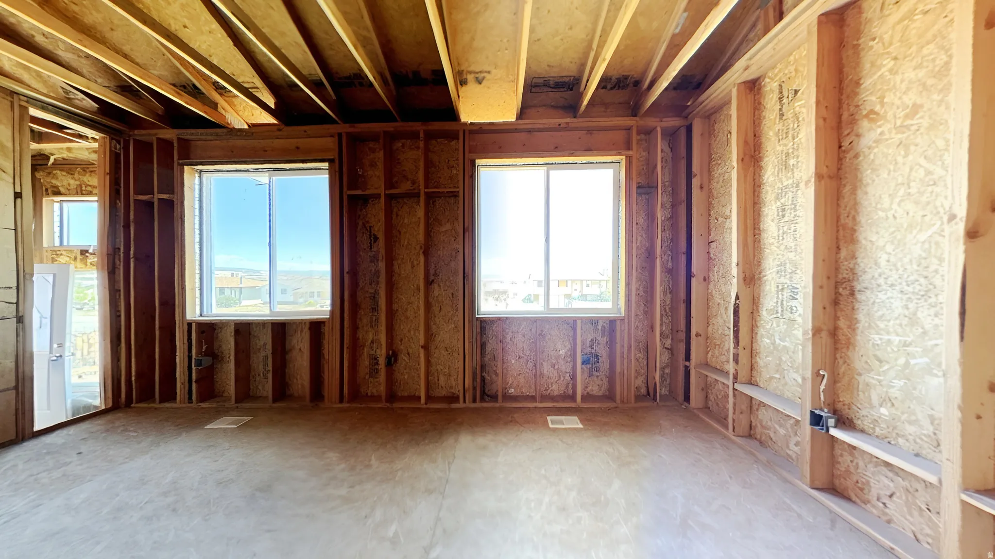 Unfinished interior space featuring exposed wood framing and subfloor