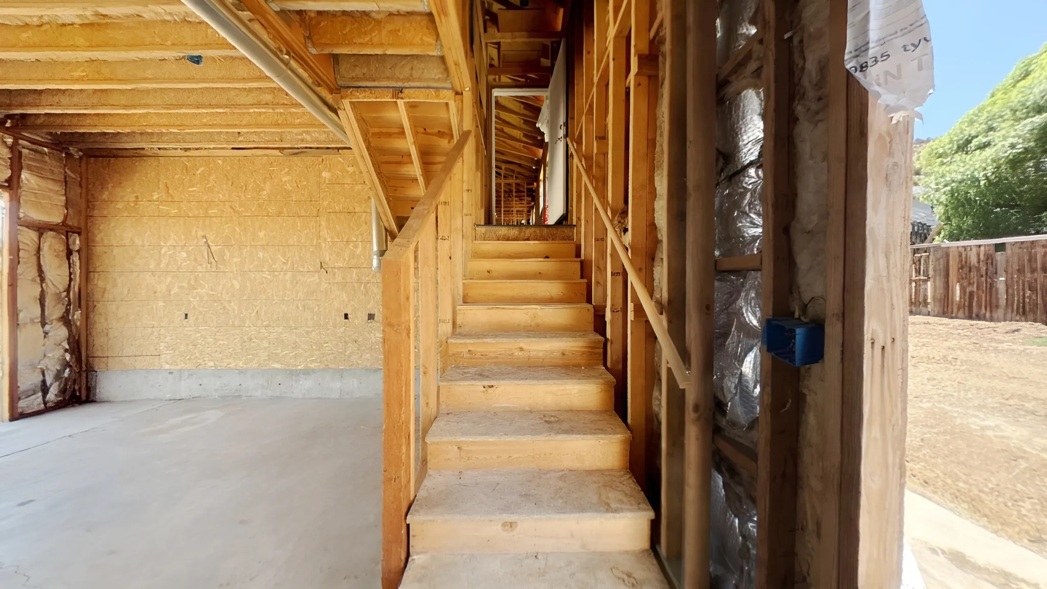 Unfinished wood staircase with full balustrade