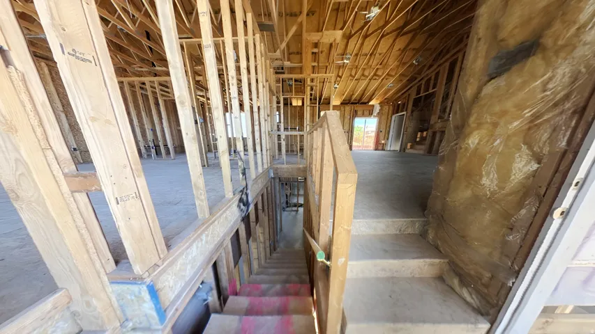 Unfinished interior framing showcasing structural elements and open floor plans