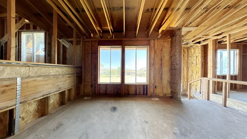 Wood framing construction with exposed ceiling joists and wall studs