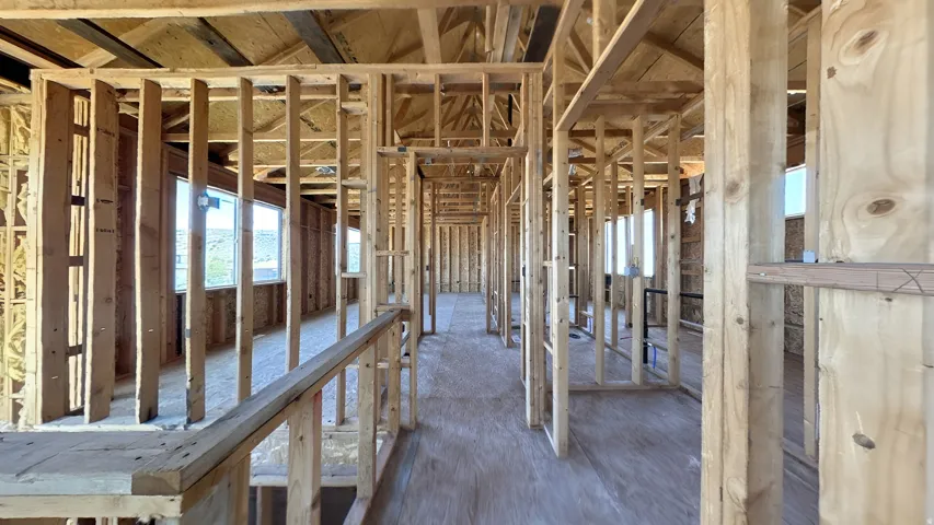 New construction framing featuring wood stud walls and exposed ceiling joists