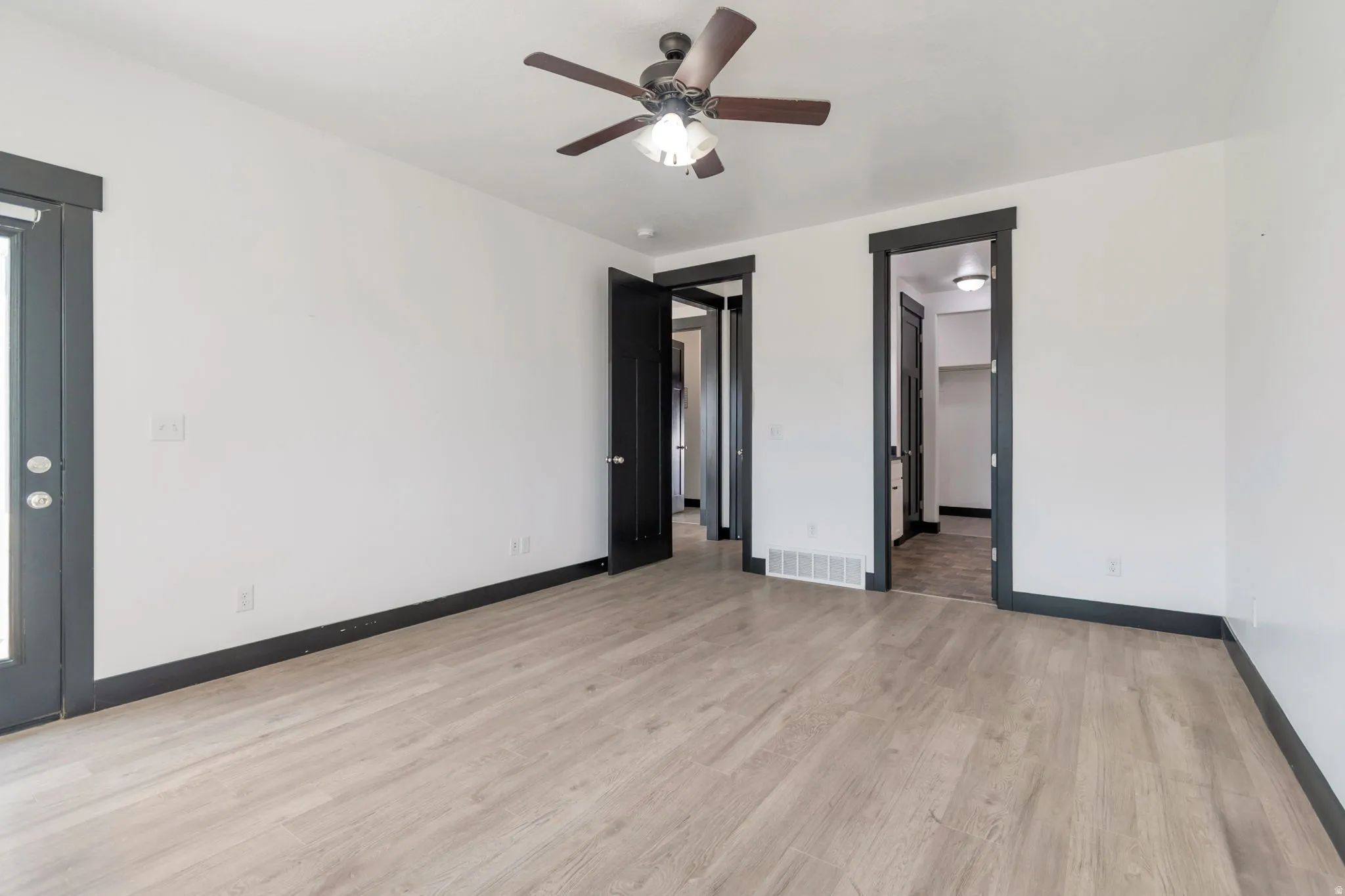 Light wood-finish flooring with a dark trim