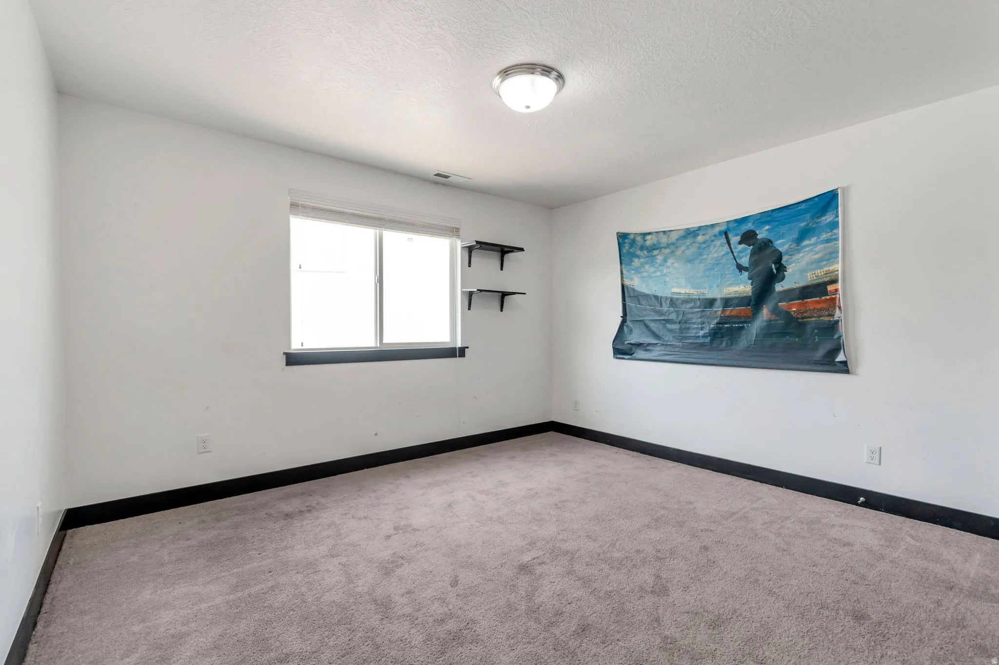 Carpeted room with a double-pane window featuring a dark sill