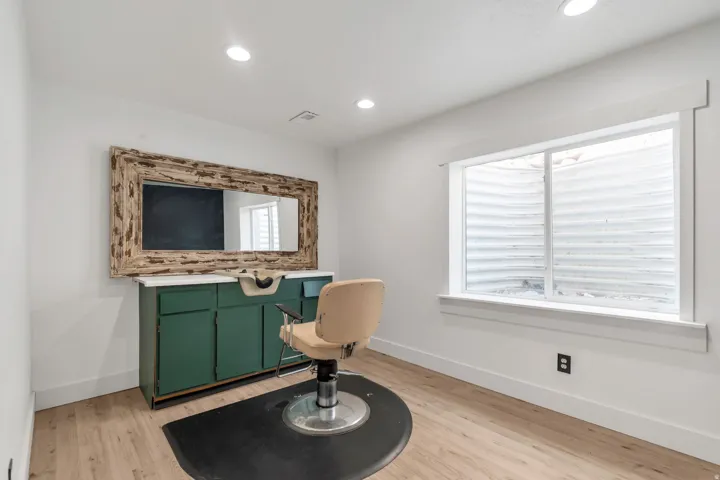 Dedicated room featuring recessed lighting, light wood-finish flooring, and a large window