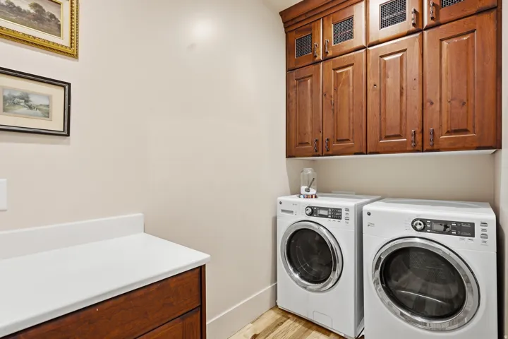 Built-in cabinetry with paneled doors and metal grate accents