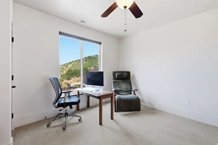 Room featuring a large window, light-colored walls, and carpet flooring