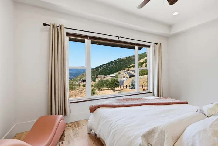 Large picture window showcasing mountain scenery and distant properties