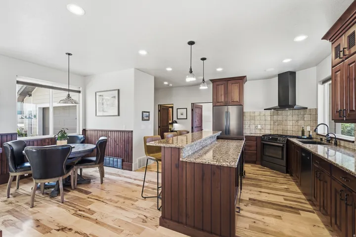 Kitchen featuring wood-finish flooring, granite countertops, and recessed lighting