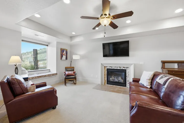 Living area with a window seat, fireplace, and recessed lighting