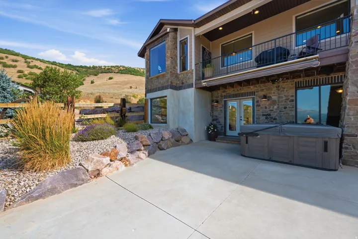 Stone and stucco exterior with a concrete patio