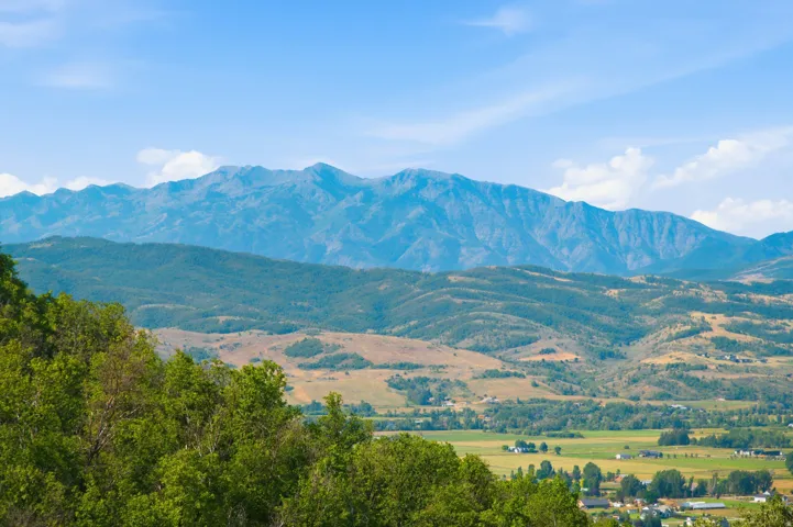 Snowbasin Ski Resort. Expansive mountain range backdrop with rolling foothills and a valley landscape