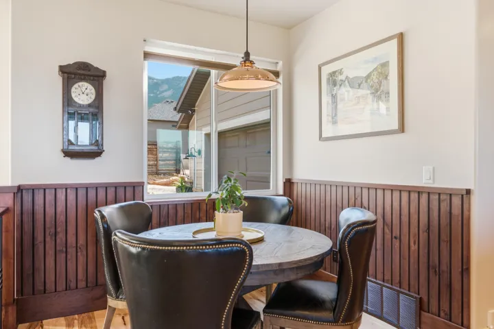 Dining nook featuring wood-finish wainscoting and light wall paint